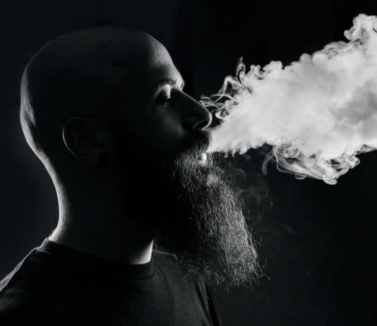 man smoking with black background