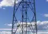 a tall metal tower sitting on top of a lush green field