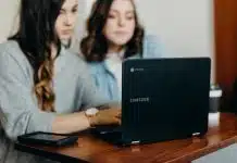 two woman using laptop